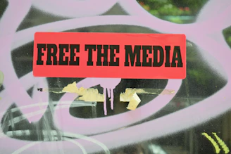 a red sign that reads free the media