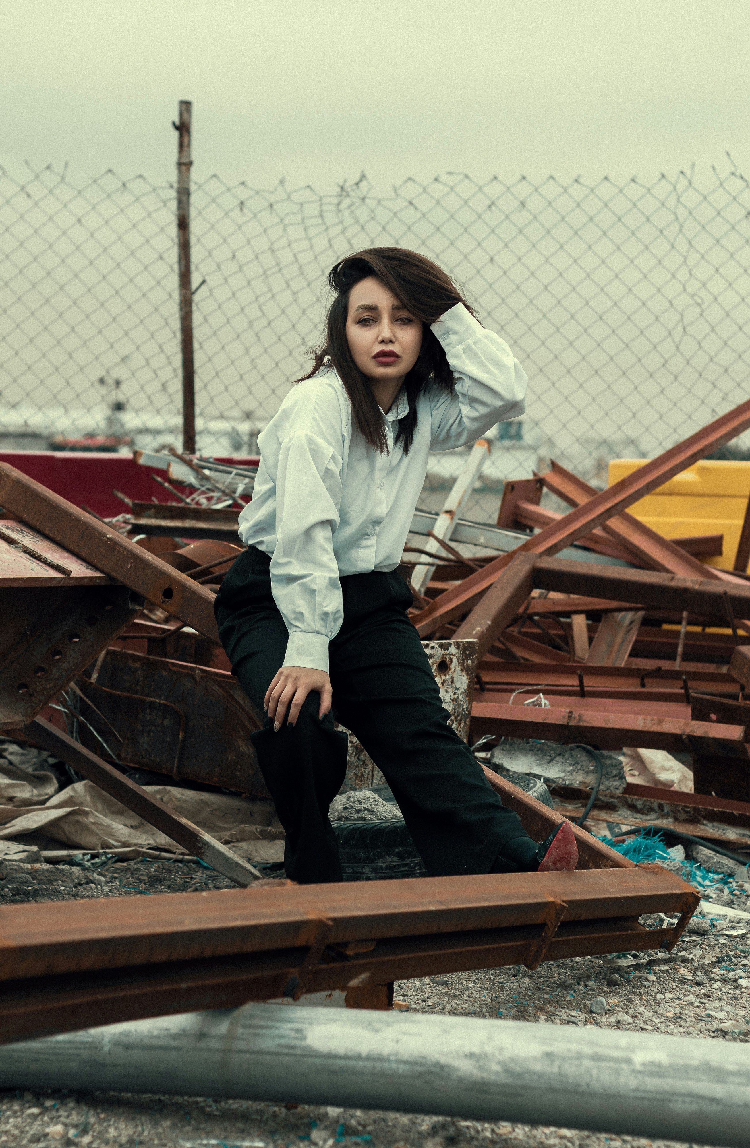 a woman in a white shirt and black pants