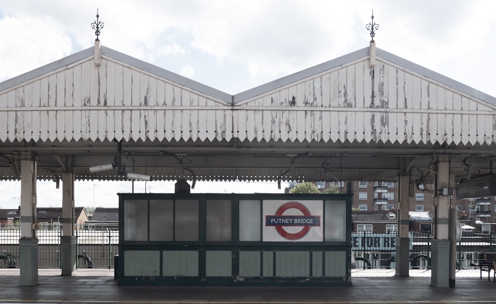 a train station with a sign on the side of it