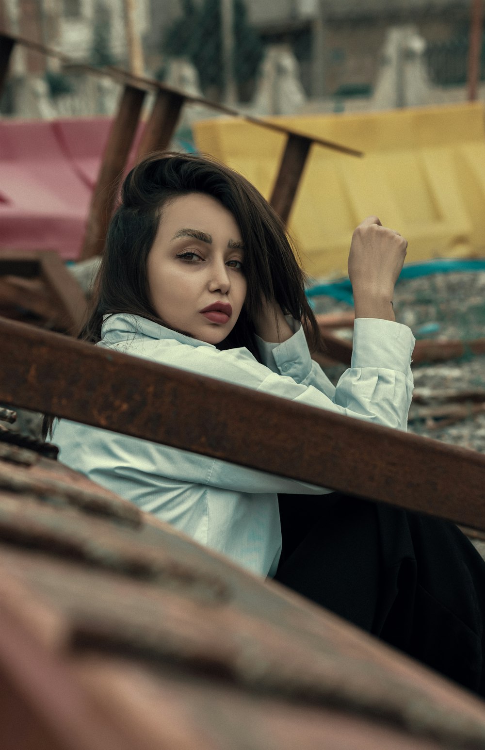 a woman sitting on a bench in the rain