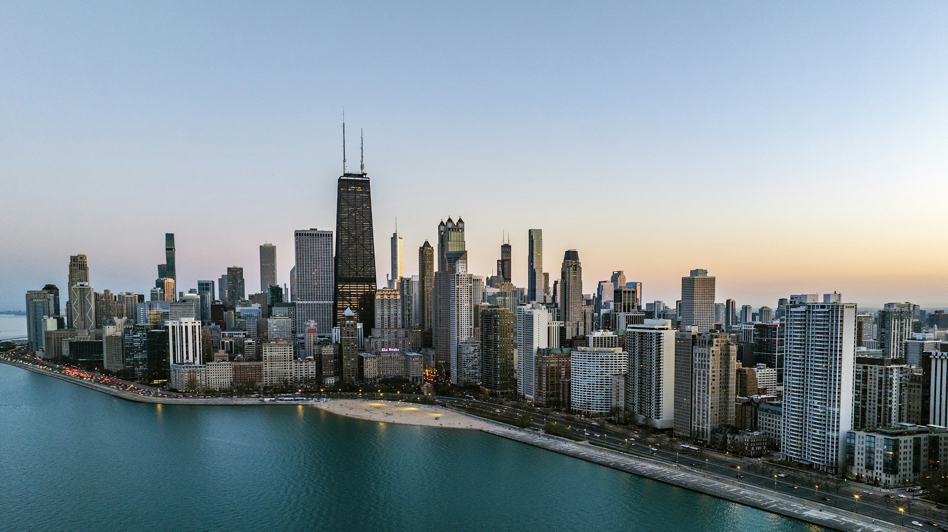 an aerial view of a large city next to a body of water