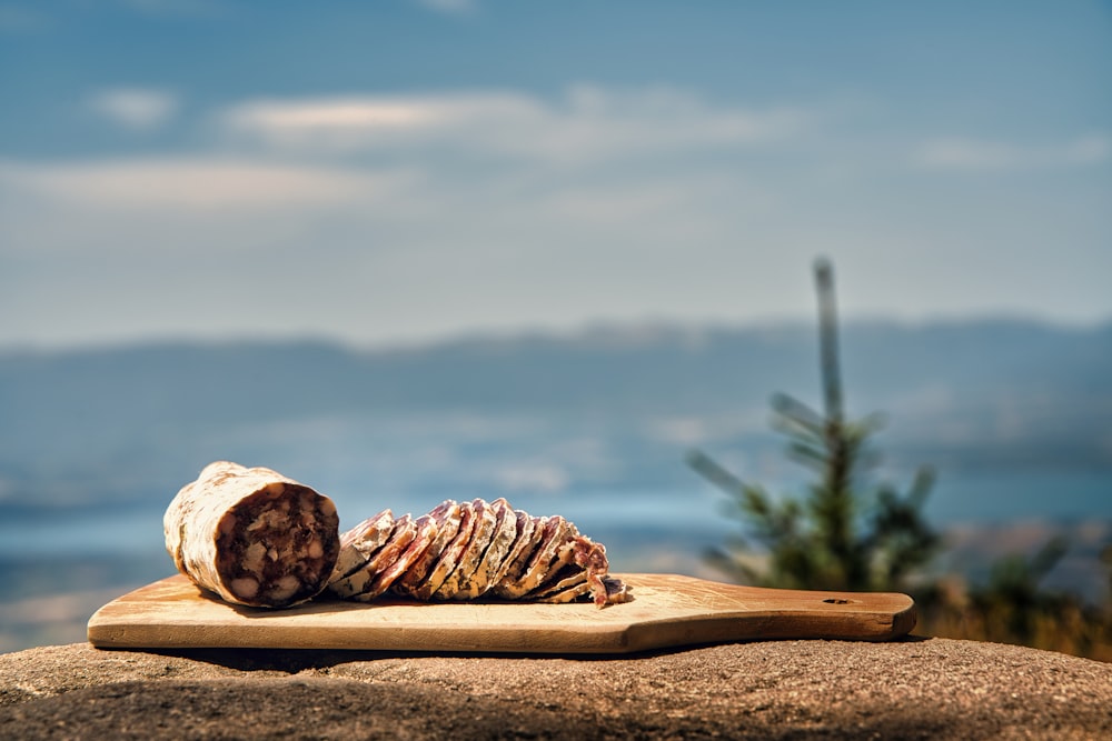 a piece of bread sitting on top of a wooden board