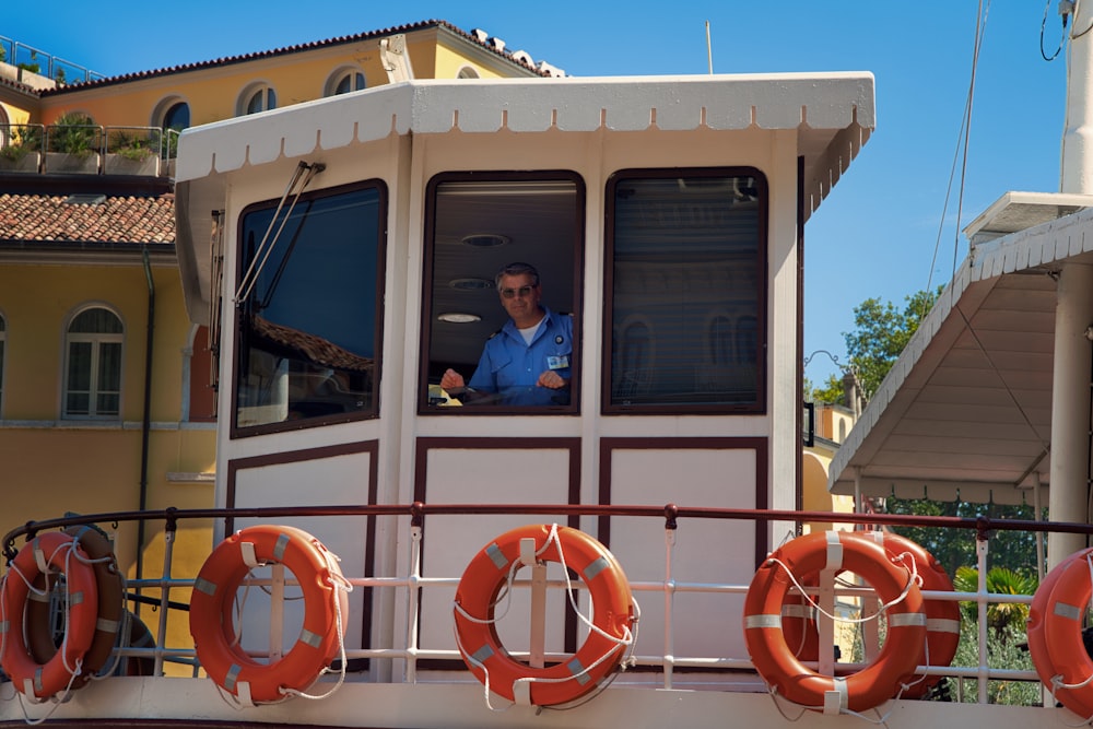 a man in a blue shirt driving a boat