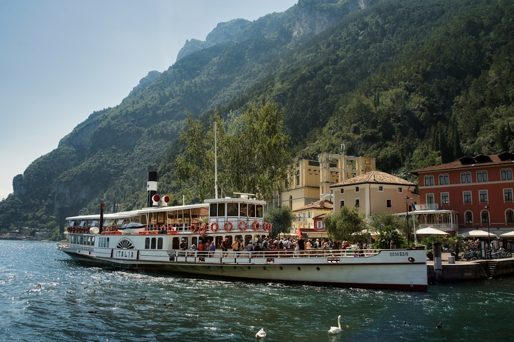 a large boat with people on it in the water