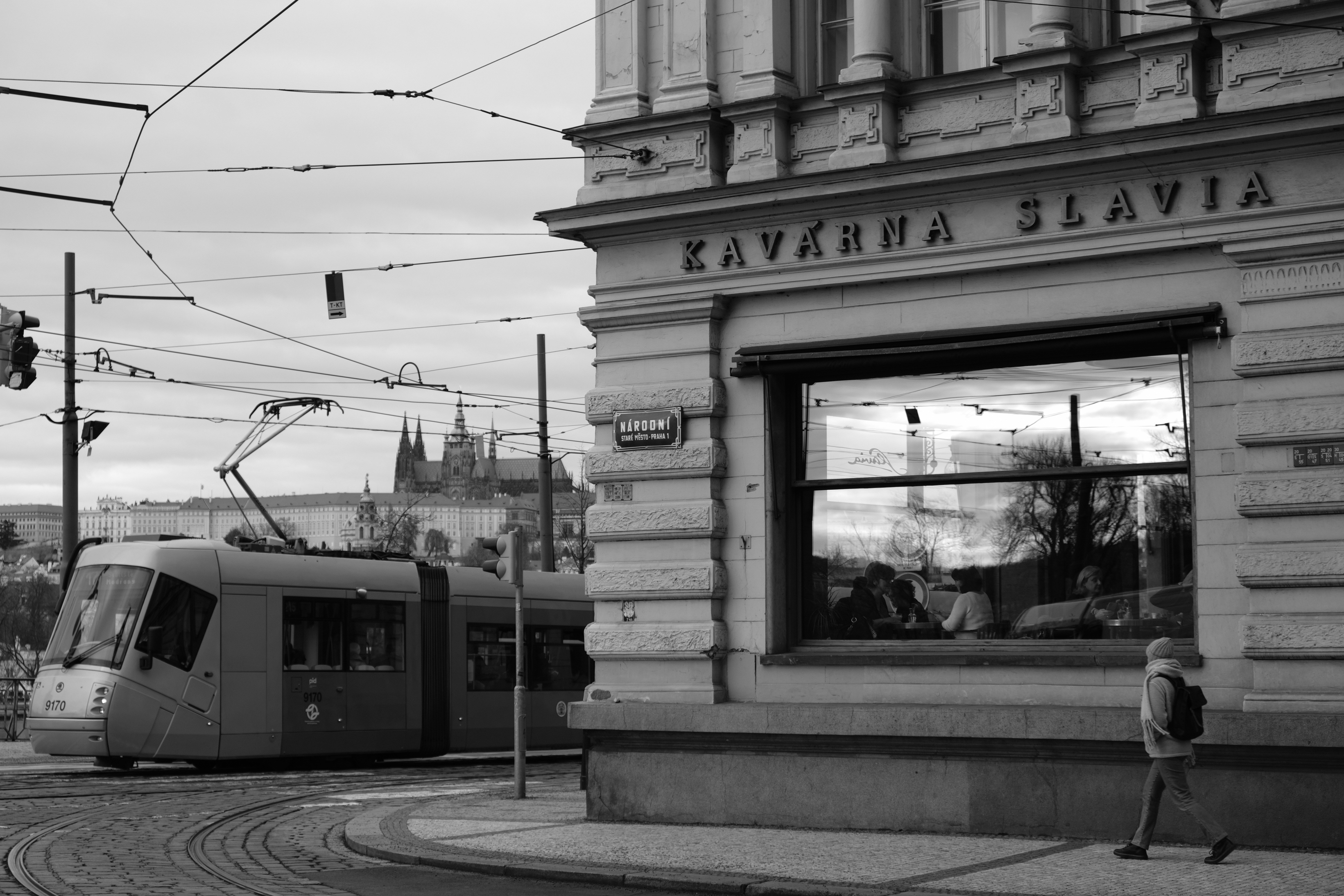 a black and white photo of a trolley on a street