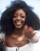 A smiling Black woman with an afro