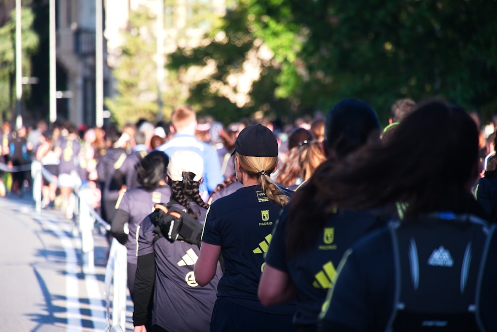 a crowd of people walking down a street