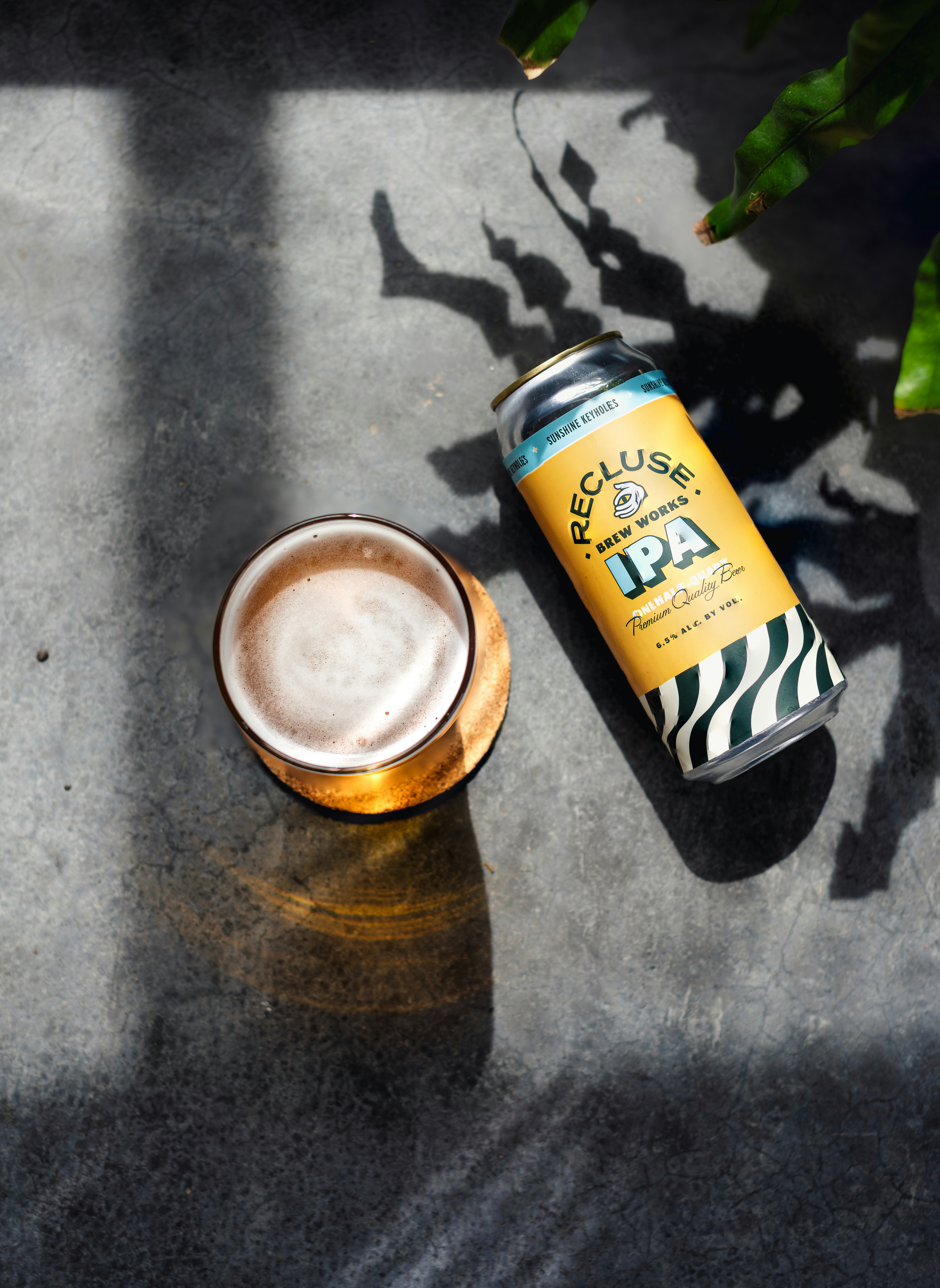 a can of beer next to a glass of beer