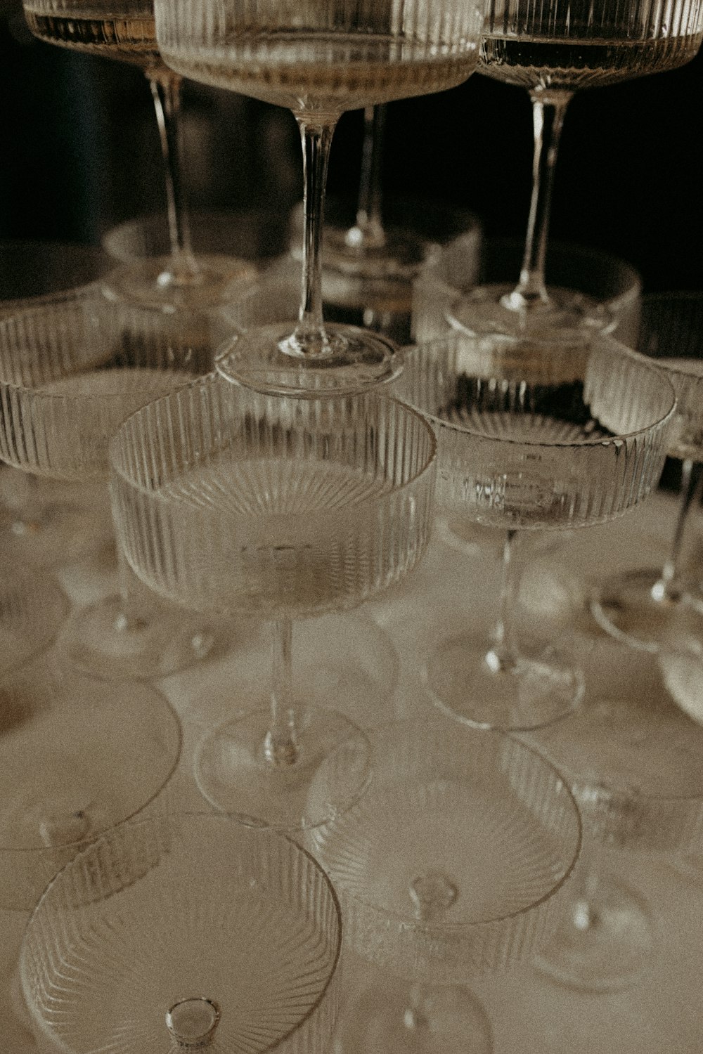 a table topped with lots of wine glasses
