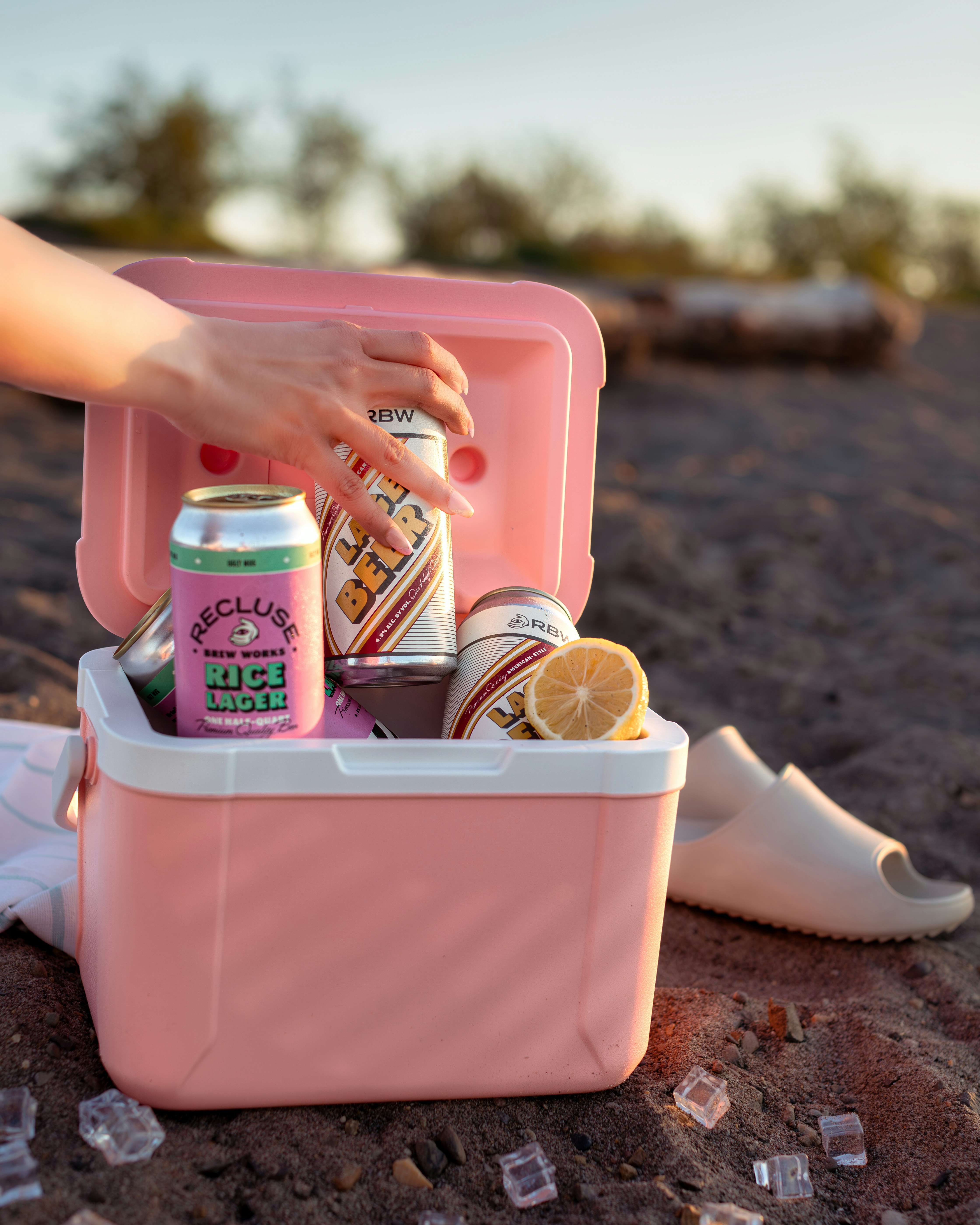 a pink cooler filled with lots of different types of drinks
