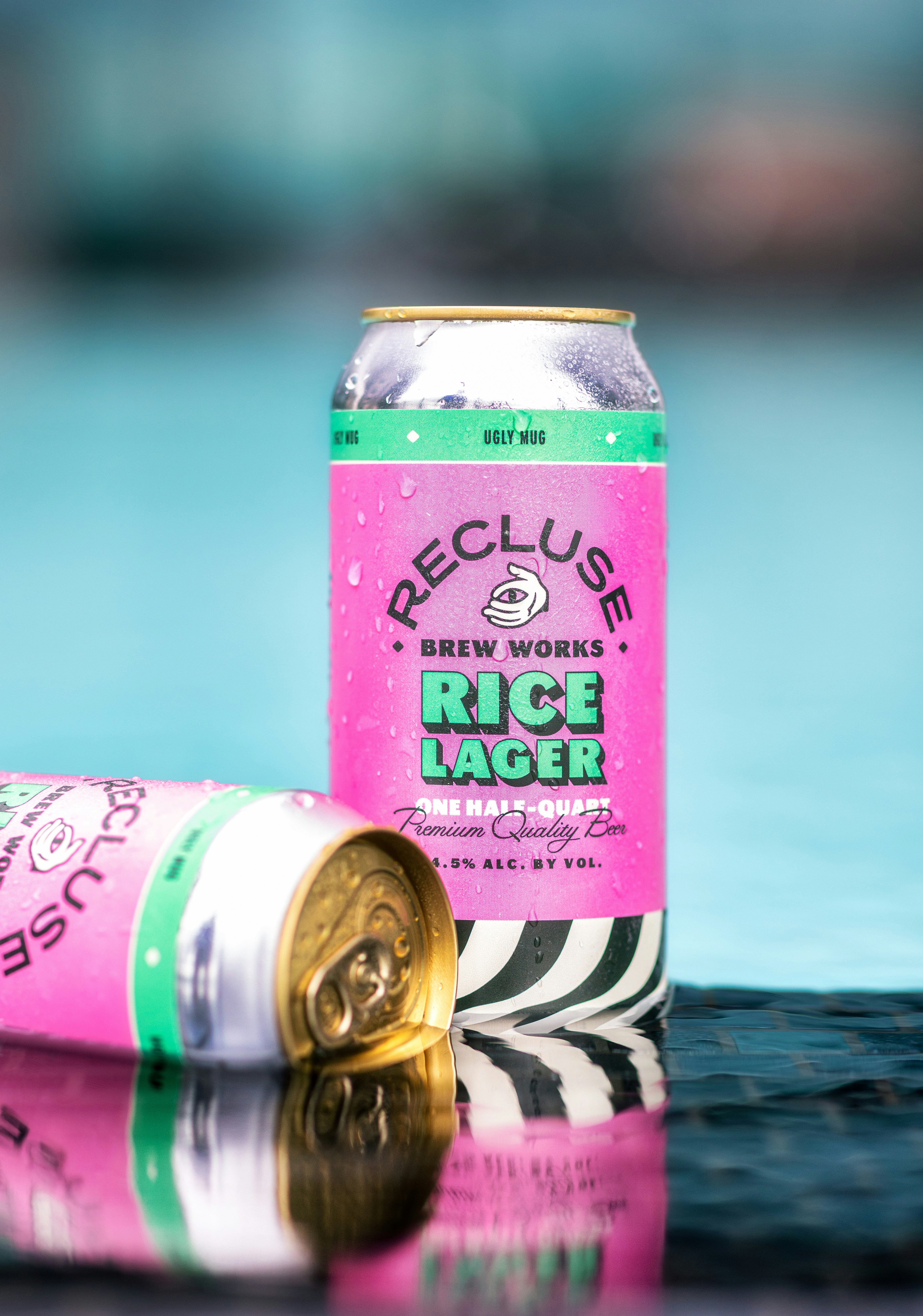 a can of rice lager next to a pool