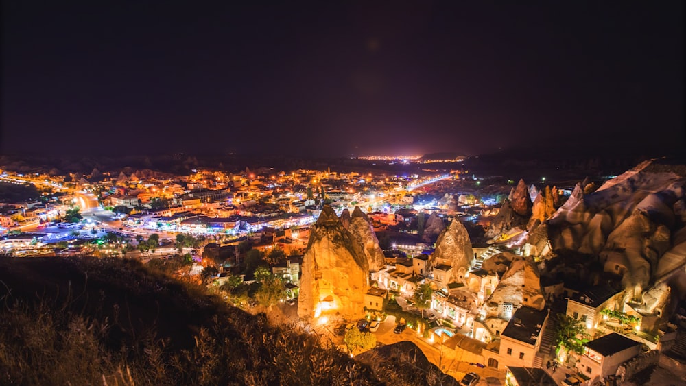 a night time view of a city from a hill