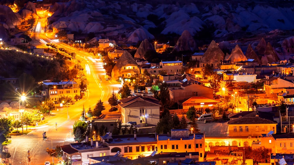 a night view of a town with a mountain in the background