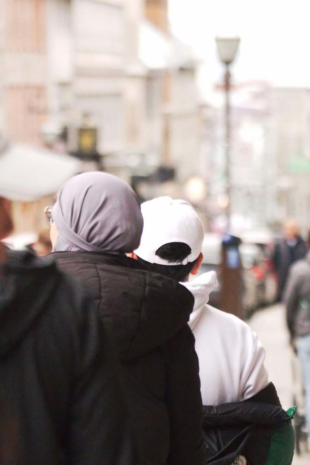 a couple of people walking down a street