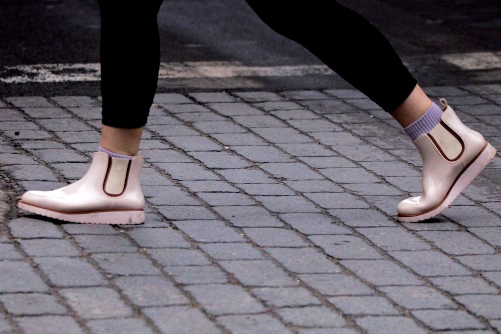 a close up of a person's shoes on a sidewalk