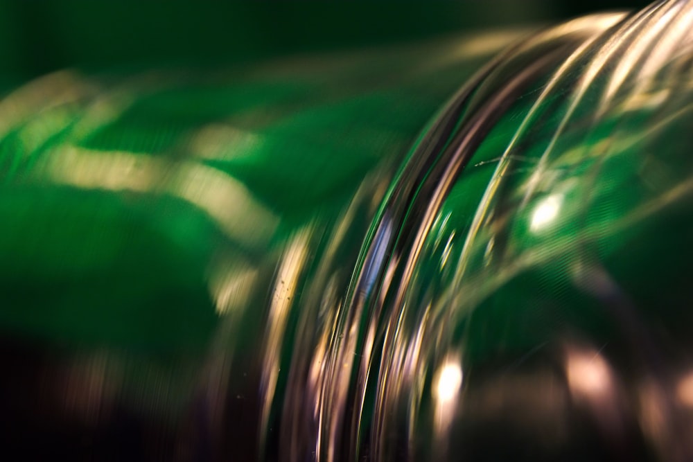 a close up of a green bottle with a blurry background
