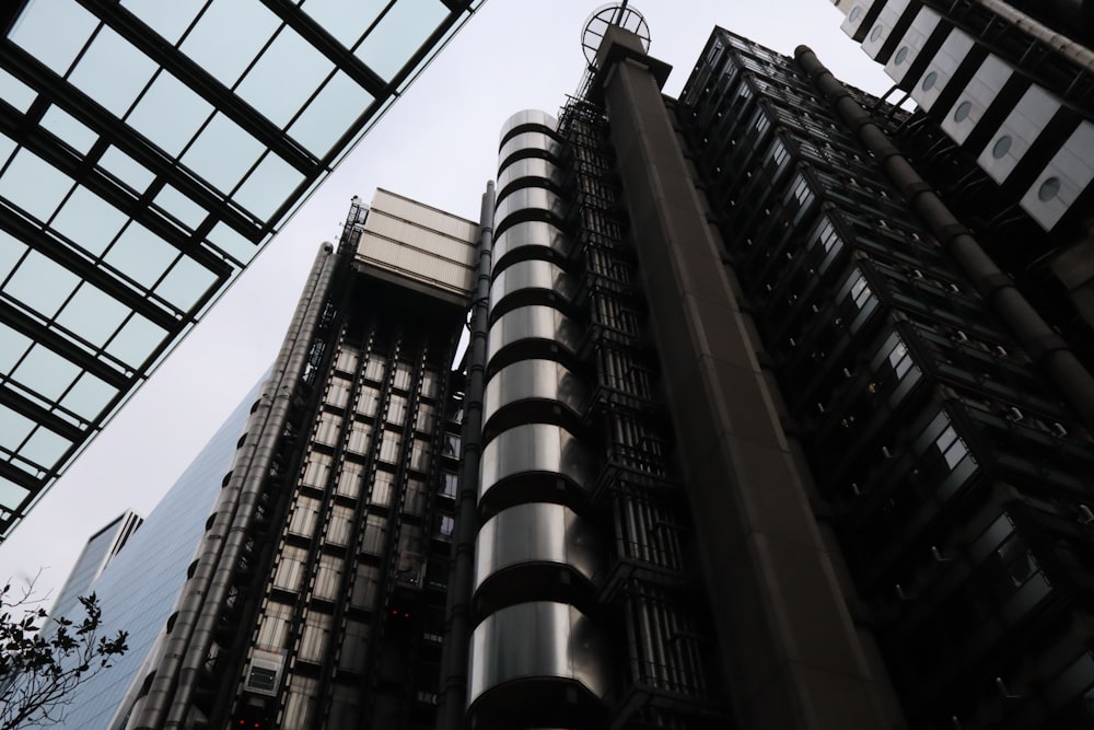 a tall building with lots of windows next to other buildings