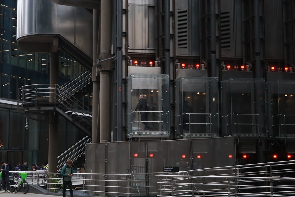 a group of people standing outside of a tall building