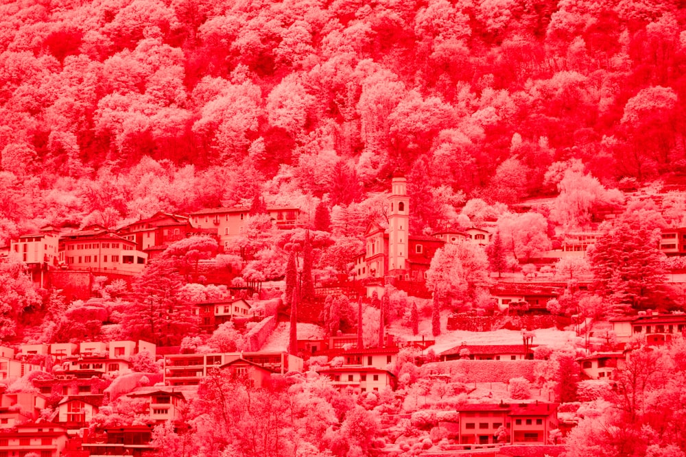 a red and white photo of a city on a hill