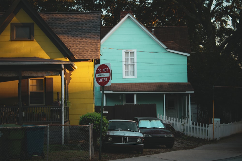 a couple of cars parked in front of a house