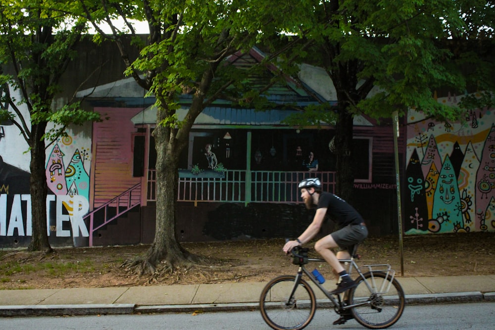 a man riding a bike down a street