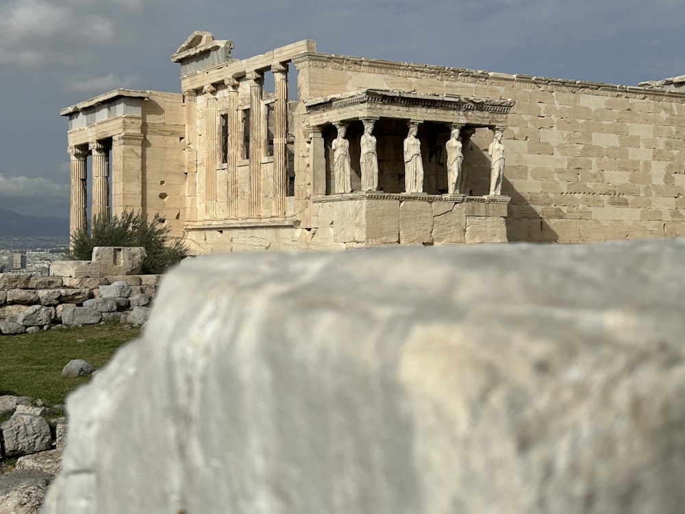 a large stone structure with two statues on top of it