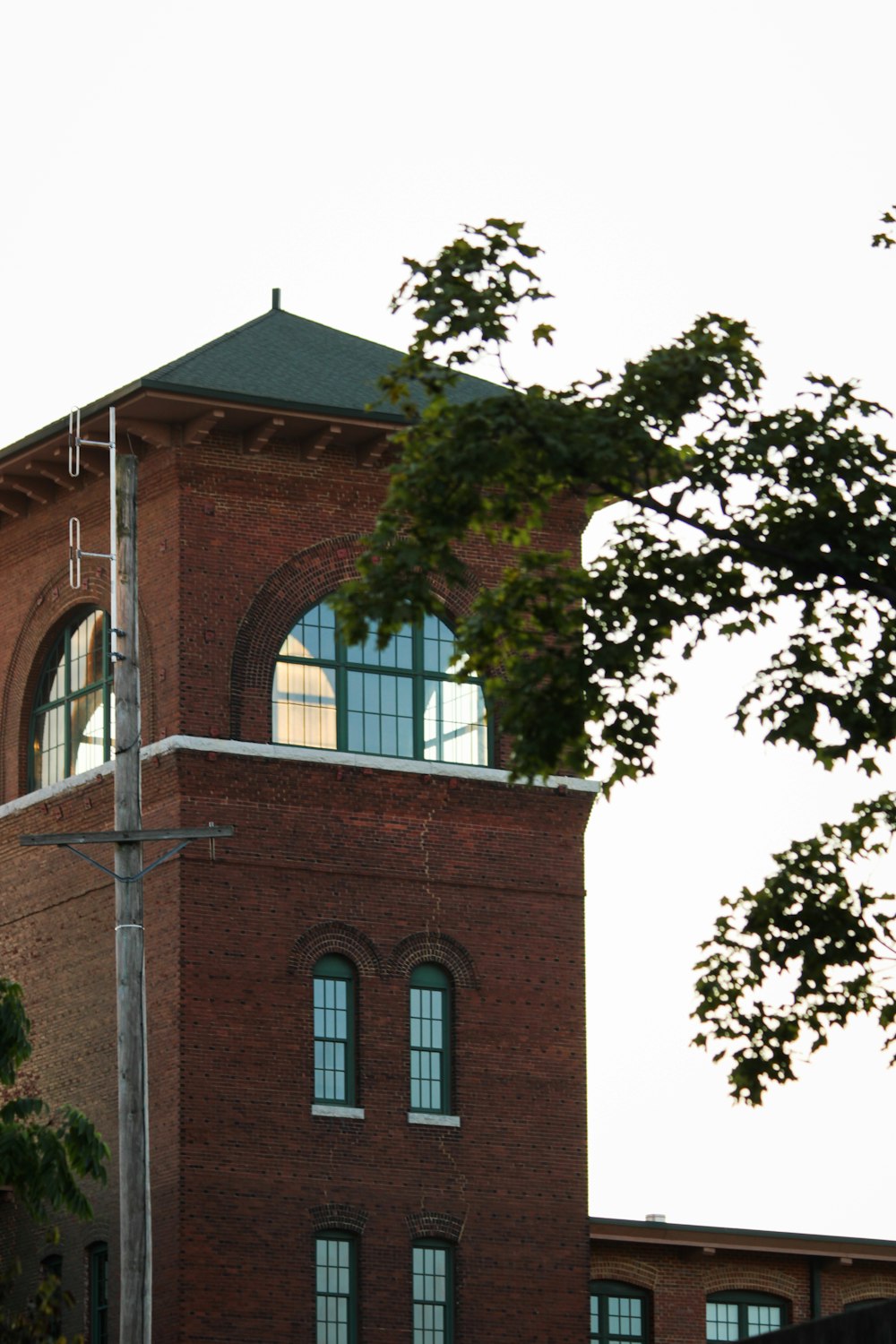 a tall brick building with a clock on the top of it