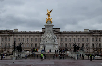 a group of people standing in front of a large building