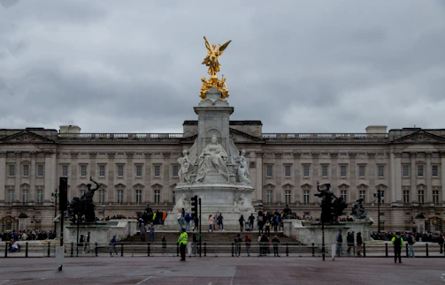 a group of people standing in front of a large building