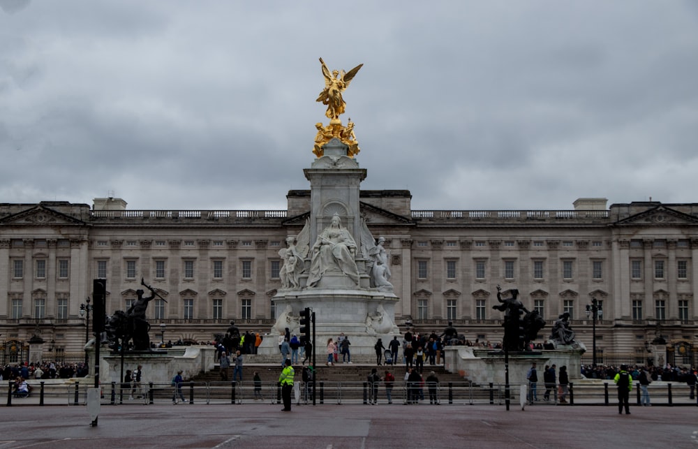 a group of people standing in front of a large building