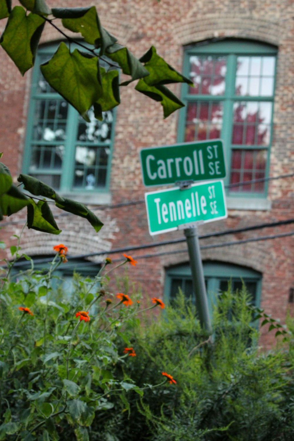 a street sign in front of a brick building