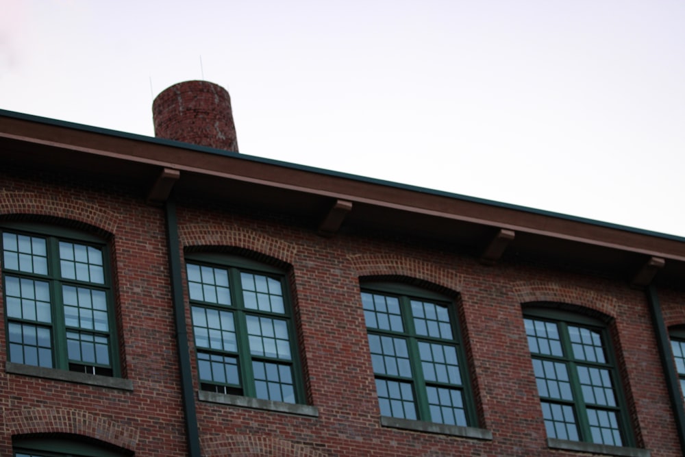 a red brick building with four windows and a clock