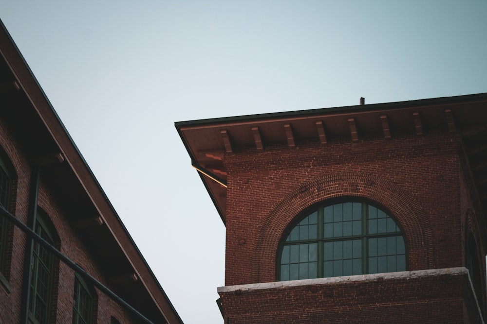 a tall brick building with a clock on it's side