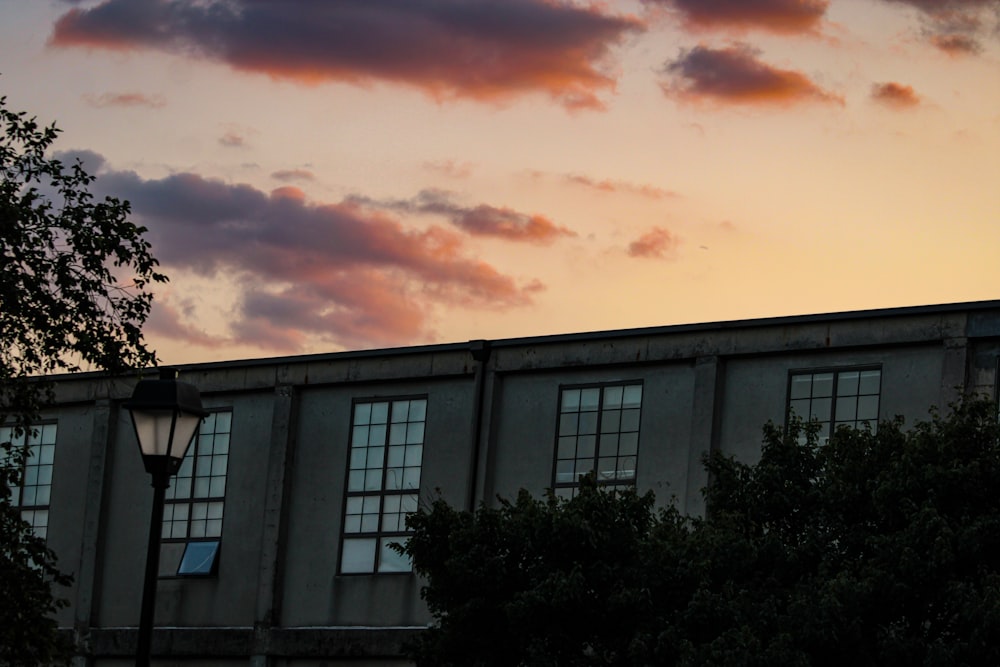 a building with many windows and a street light in front of it