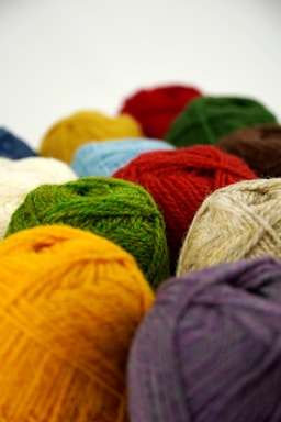 a group of balls of yarn sitting next to each other