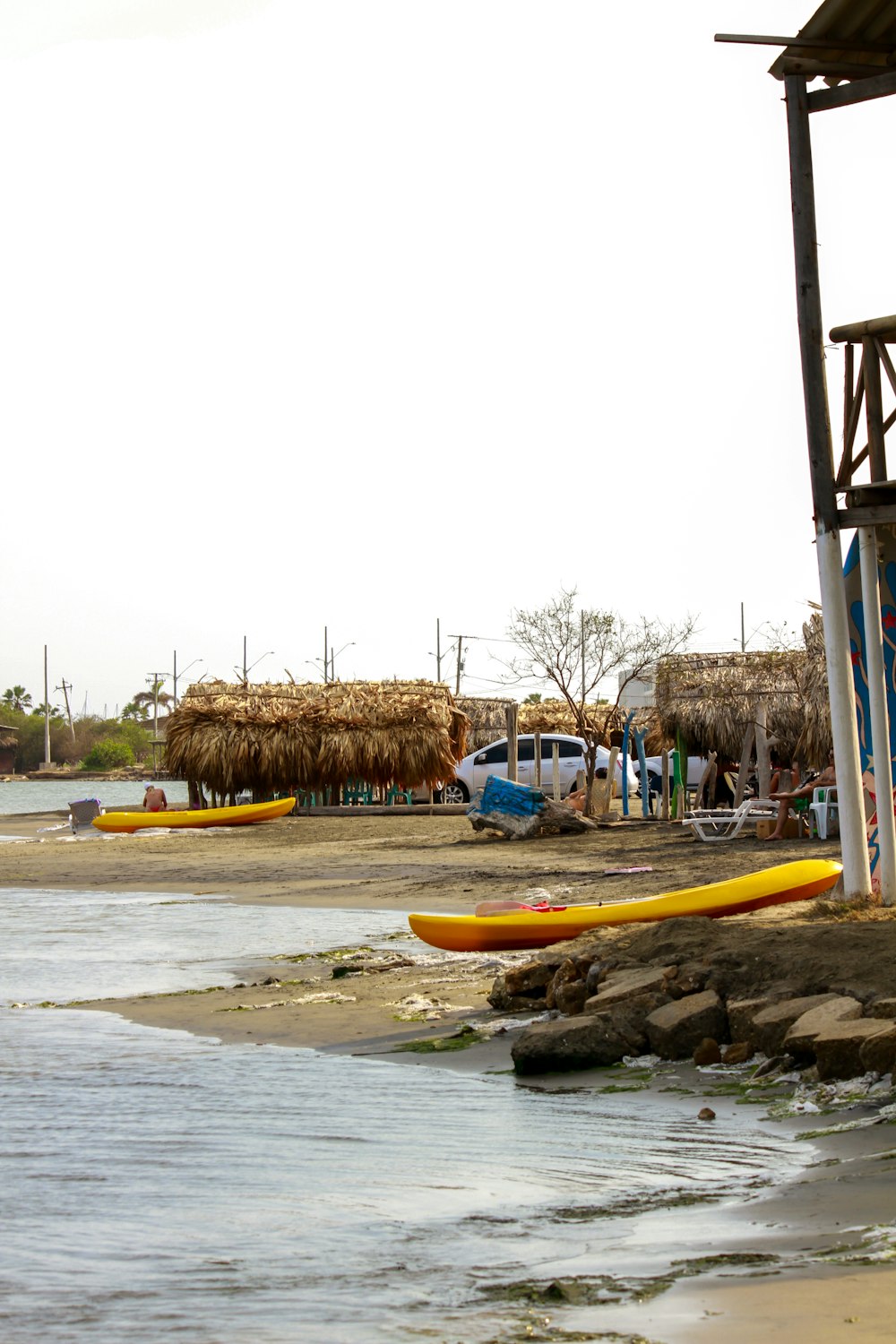 a couple of surfboards sitting on top of a sandy beach