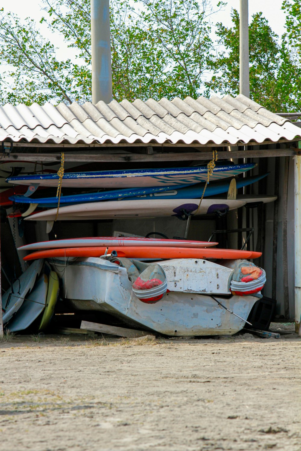 a bunch of surfboards that are in a shed
