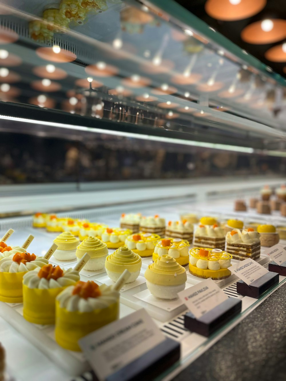 a display case filled with lots of different types of desserts