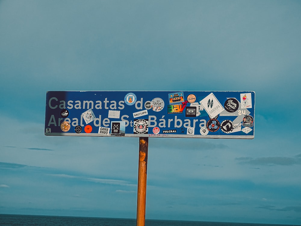 a street sign with a lot of stickers on it