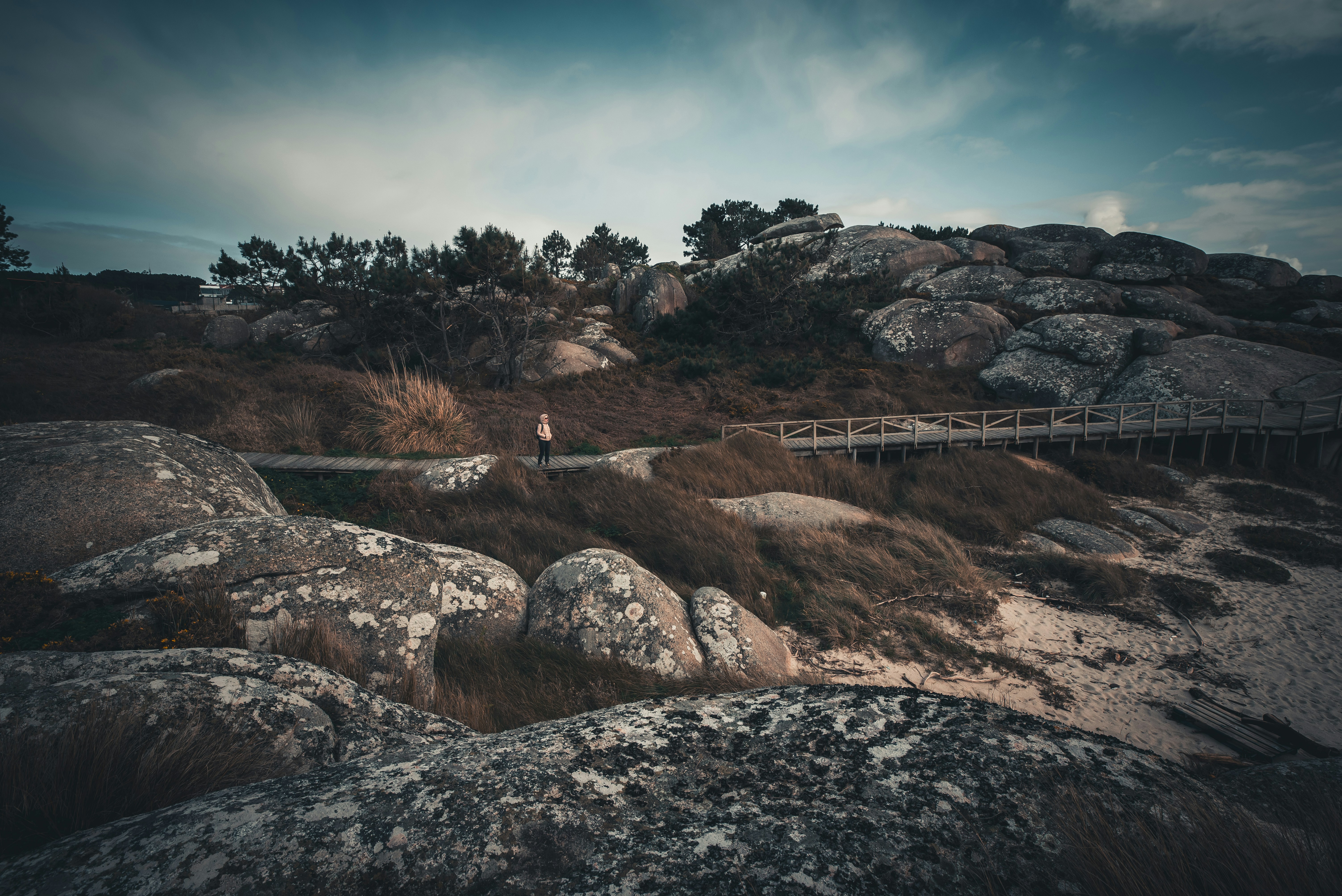 a person walking on a path between two large rocks