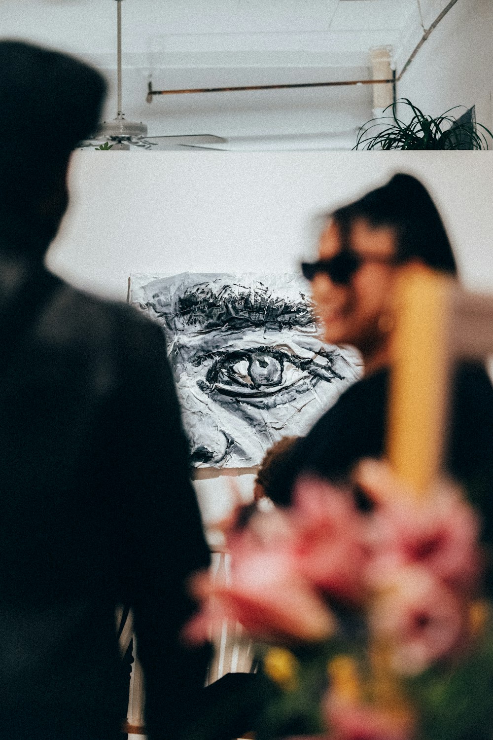 a man and a woman standing in front of a painting