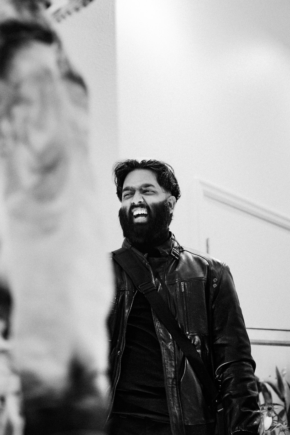 a black and white photo of a man smiling