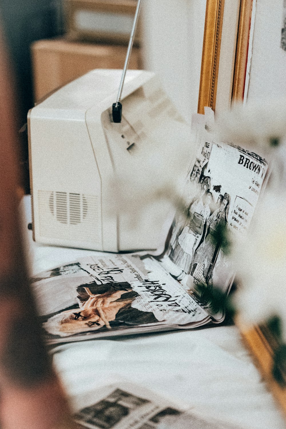 a white radio sitting on top of a table next to a mirror