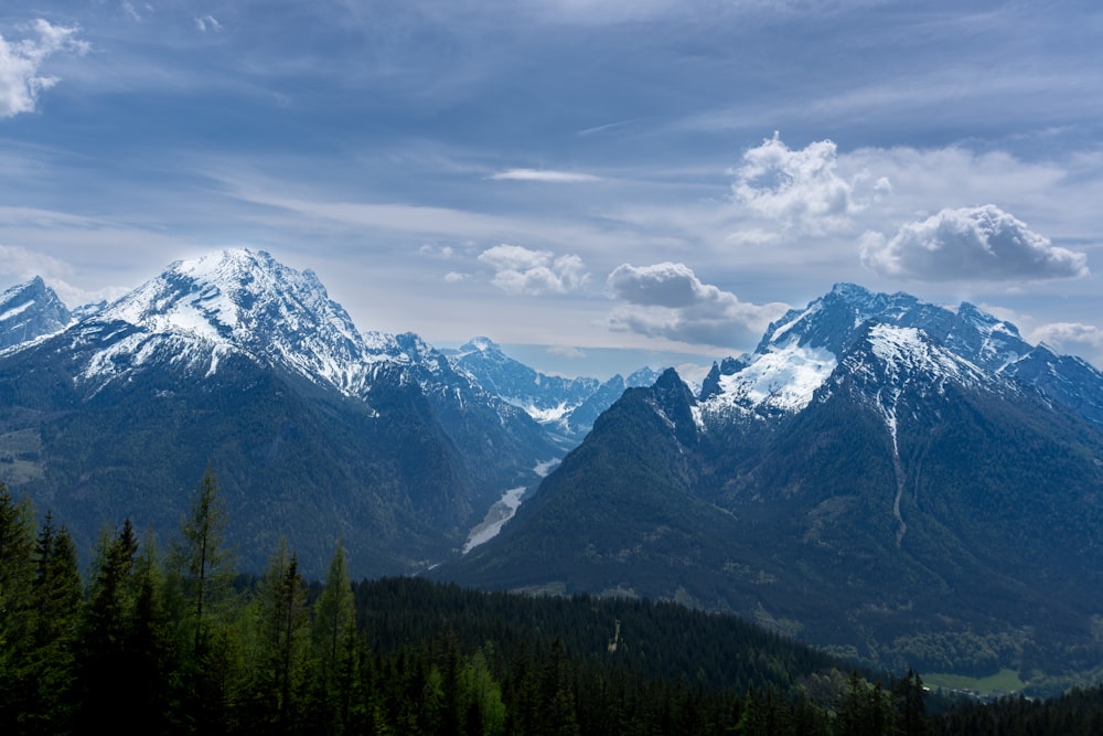 a mountain range with snow capped mountains in the distance