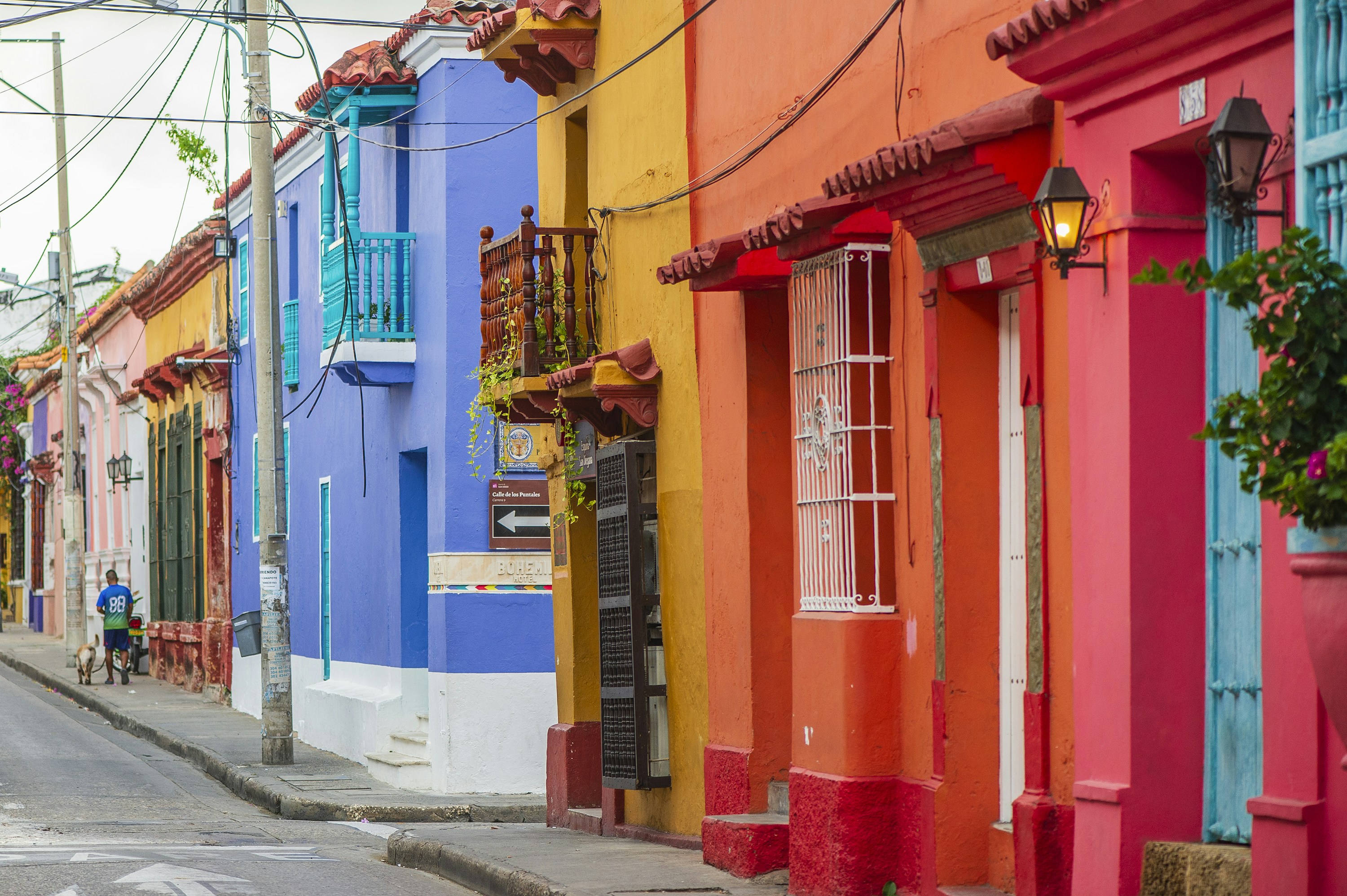 a row of colorful buildings on a city street, 