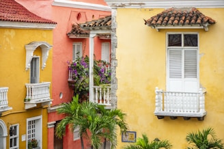 a row of colorful buildings with white balconies