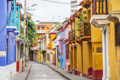 a narrow city street lined with colorful buildings
