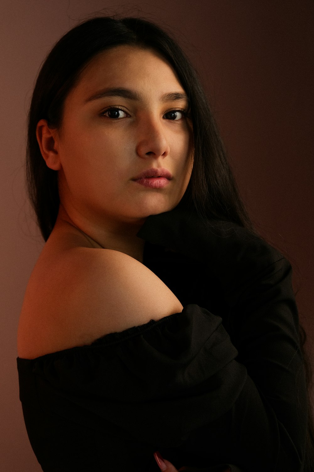 a woman in a black dress posing for a picture