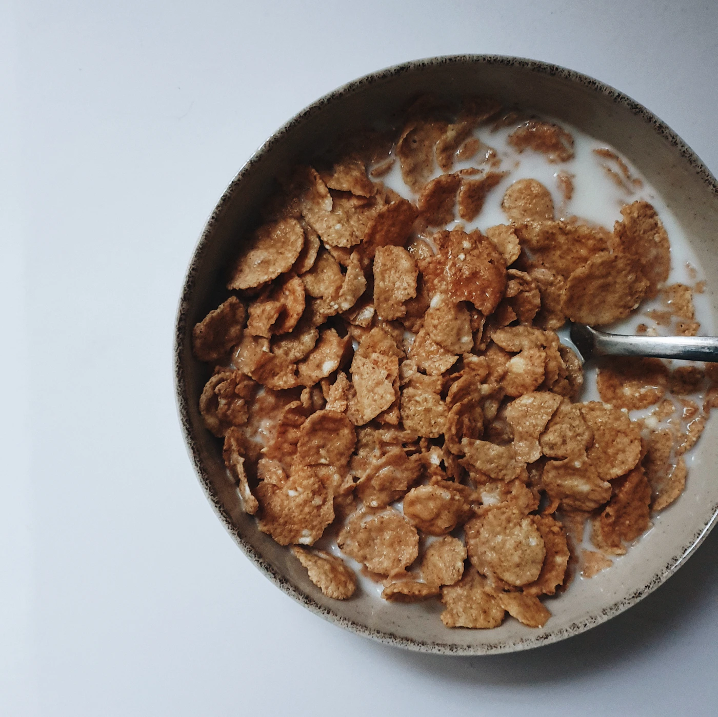 Bowl of breakfast cereal with milk and a spoon