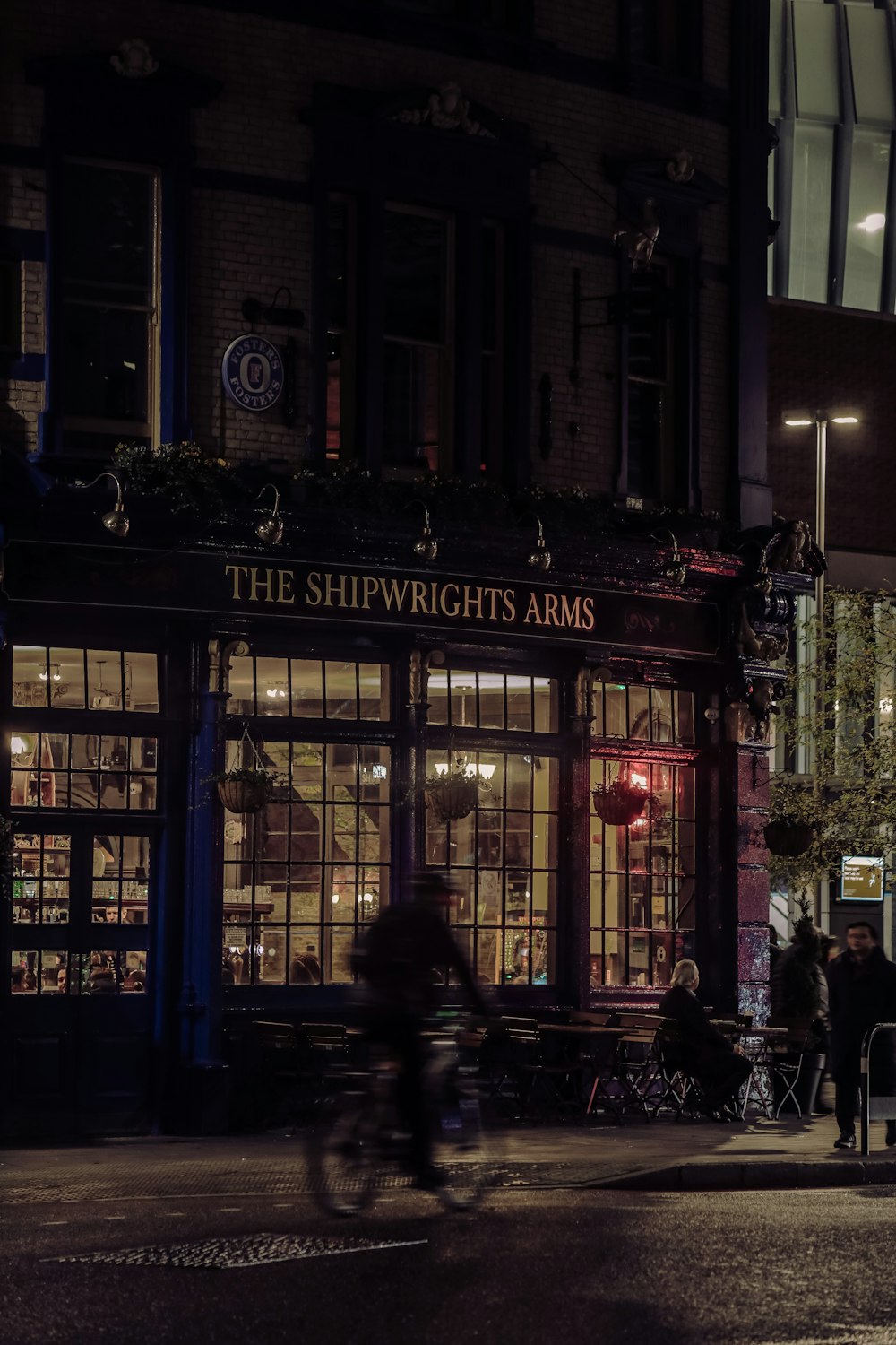 a man riding a bike down a street at night